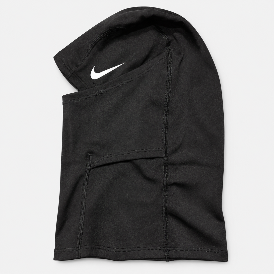 A man wearing a white Nike balaclava face covering with a dark gray Nike swoosh on the forehead and a small black Nike logo patch on the neck, paired with a dark gray athletic shirt against a light gray background.